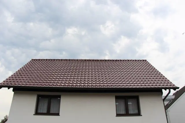 Neu eingedecktes Satteldach mit roten Tondachsteinen